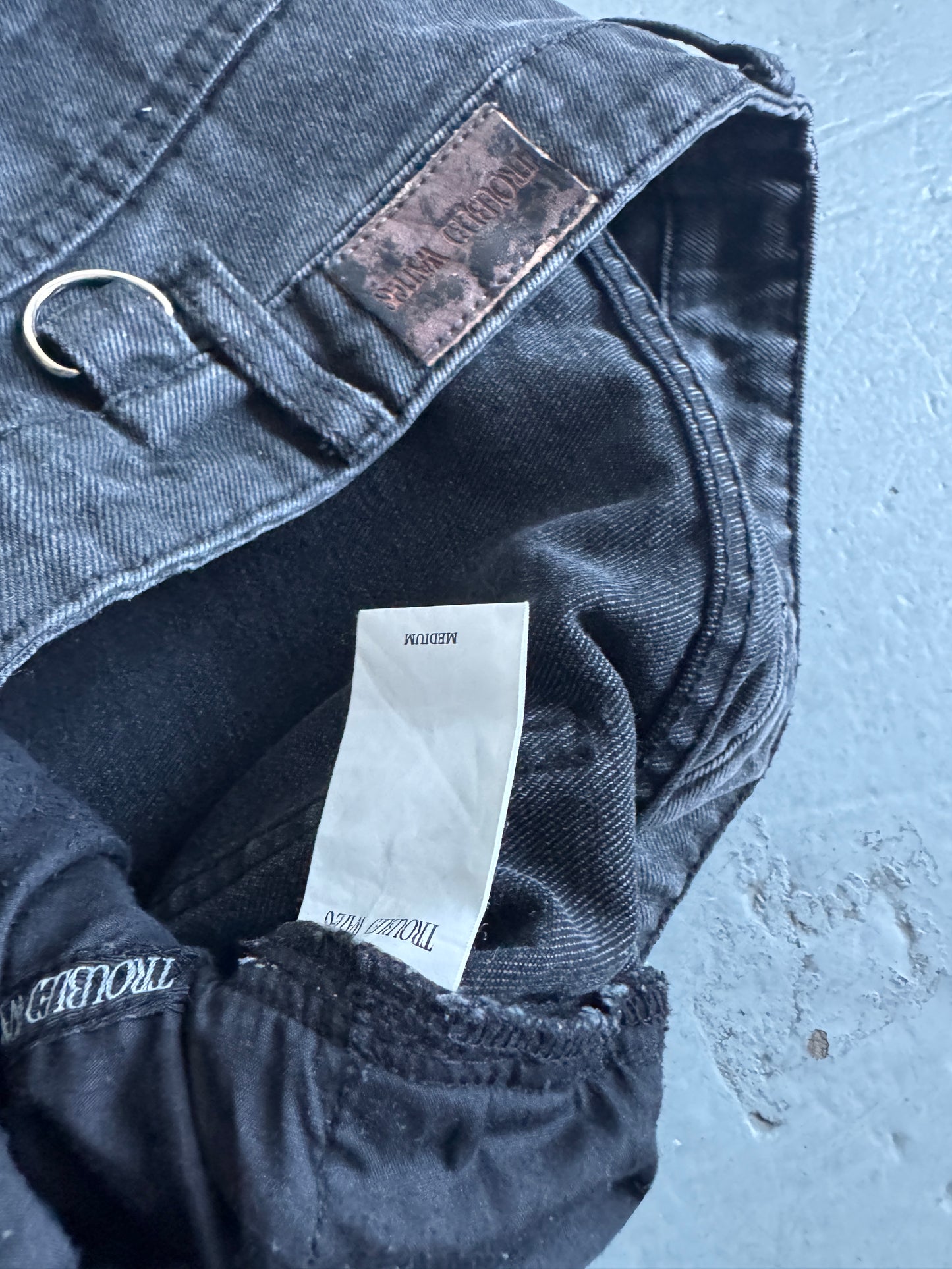 troubled waters zip waist distressed denim